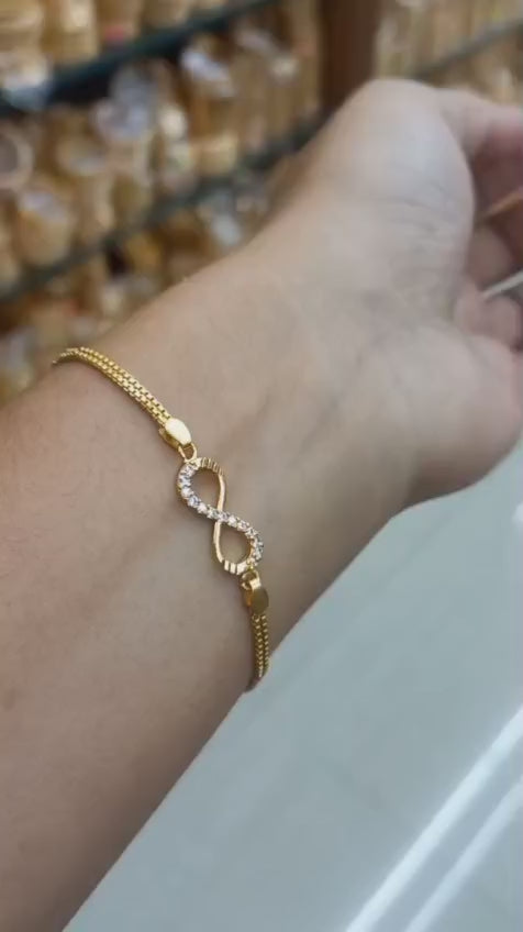 Daily wear premium gold plated white AD Stone infinity design hand chain Code : NL0078